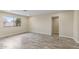 Bright bedroom featuring neutral walls, tile flooring, and a large window allowing natural light at 20210 N 124Th Dr, Sun City West, AZ 85375