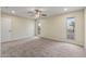 Bedroom featuring neutral walls, carpet, a ceiling fan, and natural light from two windows at 20210 N 124Th Dr, Sun City West, AZ 85375