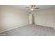 Neutral bedroom with a ceiling fan, neutral carpet, and access to a walk-in closet at 20210 N 124Th Dr, Sun City West, AZ 85375