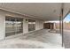 A covered patio has sliding glass doors and provides a relaxing space to enjoy the outdoors at 20210 N 124Th Dr, Sun City West, AZ 85375