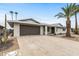 Inviting single-story home featuring a well-maintained yard with desert landscaping and a spacious two-car garage at 20210 N 124Th Dr, Sun City West, AZ 85375