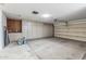 The garage features storage cabinets on one wall and an automatic garage door at 20210 N 124Th Dr, Sun City West, AZ 85375