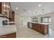 Modern kitchen with quartz countertops, stainless appliances, and a large central island with pendant lighting at 20210 N 124Th Dr, Sun City West, AZ 85375