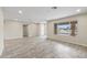 Spacious open living room featuring tile flooring, neutral walls, recessed lighting, and a large window at 20210 N 124Th Dr, Sun City West, AZ 85375