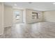 Bright open living room featuring tile flooring, neutral walls, recessed lighting, and a doorway at 20210 N 124Th Dr, Sun City West, AZ 85375