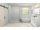 Bright bathroom features a glass shower, modern tub, and white vanity with double sinks at 2024 N Woodburne Pl, Chandler, AZ 85224