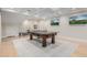 Recreation room with ping pong table and large screen televisions and light wood floors at 20406 E Sunset Ct, Queen Creek, AZ 85142