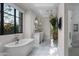 A bathroom that combines a soaking tub, a view, and a glass shower for an oasis experience at 20406 E Sunset Ct, Queen Creek, AZ 85142