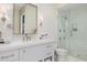 Elegant bathroom featuring white cabinets, shower with glass door, and quartz countertops at 20406 E Sunset Ct, Queen Creek, AZ 85142