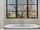 A soaking tub beneath a window offering natural light and views at 20406 E Sunset Ct, Queen Creek, AZ 85142