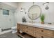 Bright bathroom showcasing a walk-in shower, a vessel sink, and a decorative mirror at 20406 E Sunset Ct, Queen Creek, AZ 85142