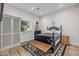 Comfortable bedroom with hardwood floors, a dark wood bed frame, and a window with natural light at 20406 E Sunset Ct, Queen Creek, AZ 85142