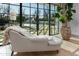 A tranquil bedroom nook showcases outdoor pool views and elegant chaise lounge seating at 20406 E Sunset Ct, Queen Creek, AZ 85142