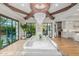 Bright dining room featuring a marble table, a crystal chandelier and large windows to view exterior at 20406 E Sunset Ct, Queen Creek, AZ 85142