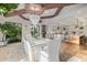 Open-concept dining room with marble table, crystal chandelier, and views to kitchen and backyard at 20406 E Sunset Ct, Queen Creek, AZ 85142