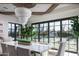 Dining room with large windows overlooking the backyard pool and featuring a tiered crystal chandelier at 20406 E Sunset Ct, Queen Creek, AZ 85142