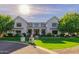 Grand light-colored brick home with beautifully manicured landscaping, creating a captivating and inviting atmosphere at 20406 E Sunset Ct, Queen Creek, AZ 85142