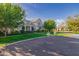 Attractive light-colored brick home with lush green lawn and mature trees, offering a serene and inviting outdoor space at 20406 E Sunset Ct, Queen Creek, AZ 85142