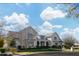 Beautiful two-story home featuring a white brick facade, manicured lawn, and mature landscaping on a sunny day at 20406 E Sunset Ct, Queen Creek, AZ 85142