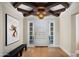 Bright foyer with wood floors, a painted door with sidelights, and stylish black bench at 20406 E Sunset Ct, Queen Creek, AZ 85142