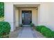 Welcoming front entrance with stylish door, manicured bushes, and brick accents at 20406 E Sunset Ct, Queen Creek, AZ 85142