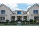 Elegant home entrance with a covered porch, decorative columns, manicured landscaping and a stone pathway at 20406 E Sunset Ct, Queen Creek, AZ 85142