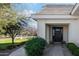 Charming home exterior with meticulous landscaping, walkway, and a stately black front door at 20406 E Sunset Ct, Queen Creek, AZ 85142