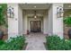 Inviting front porch with classic columns, stylish lanterns, and a decorative wreath, creating a warm welcome at 20406 E Sunset Ct, Queen Creek, AZ 85142