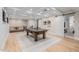 Spacious game room features a ping pong table, coffered ceiling, and sliding barn doors at 20406 E Sunset Ct, Queen Creek, AZ 85142