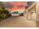 Beautiful long driveway leading to multiple garages on an estate property at dusk at 20406 E Sunset Ct, Queen Creek, AZ 85142