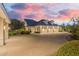 Beautiful long driveway leads to multiple garages on an estate property at dusk at 20406 E Sunset Ct, Queen Creek, AZ 85142