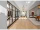 Hallway with wood floors, stylish doors, and great light, leading to additional rooms at 20406 E Sunset Ct, Queen Creek, AZ 85142