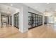 Spacious hallway featuring wood floors and glass-paneled doors to maximize natural light at 20406 E Sunset Ct, Queen Creek, AZ 85142