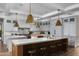 Spacious kitchen featuring a large island, marble countertops, pendant lighting, and stainless steel appliances at 20406 E Sunset Ct, Queen Creek, AZ 85142