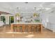 Spacious kitchen with a large wooden island, marble countertops, and overhead gold light fixtures at 20406 E Sunset Ct, Queen Creek, AZ 85142