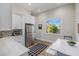 Bright kitchenette featuring stainless steel appliances, white cabinets, and modern accents at 20406 E Sunset Ct, Queen Creek, AZ 85142