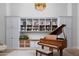 Elegant living room featuring custom built-ins and a grand piano at 20406 E Sunset Ct, Queen Creek, AZ 85142