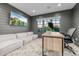 Inviting home office featuring shiplap walls, white sofa, natural light, and wood desk at 20406 E Sunset Ct, Queen Creek, AZ 85142