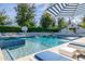 Inviting pool featuring lounge areas, striped umbrellas, fountains, and a basketball hoop at 20406 E Sunset Ct, Queen Creek, AZ 85142