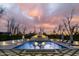 Swimming pool with a fountain and outdoor landscaping during sunset at 20406 E Sunset Ct, Queen Creek, AZ 85142