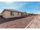 Rear exterior shot showcasing a well maintained property with a large rock yard at 20660 N Confetti Ct, Maricopa, AZ 85138