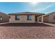 Exterior showcasing the backyard with desert landscaping, patio, and well-maintained stucco exterior at 20660 N Confetti Ct, Maricopa, AZ 85138