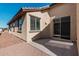 Backyard featuring a covered patio, large windows, and desert landscaping, offering a private retreat at 20660 N Confetti Ct, Maricopa, AZ 85138