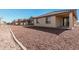 Exterior view of the backyard with low-maintenance desert landscaping and well kept stucco walls at 20660 N Confetti Ct, Maricopa, AZ 85138