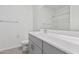 Bright bathroom featuring a modern vanity, neutral color palette, and a shower-tub combo at 20660 N Confetti Ct, Maricopa, AZ 85138