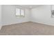 A bright, carpeted bedroom with natural light coming through the window blinds at 20660 N Confetti Ct, Maricopa, AZ 85138