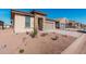 Single-story home with desert landscaping, a stone-accented entryway, and an attached two-car garage at 20660 N Confetti Ct, Maricopa, AZ 85138