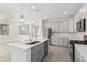 Kitchen with stainless steel appliances, gray cabinets, tile floors, and island with a sink at 20660 N Confetti Ct, Maricopa, AZ 85138