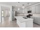 Modern kitchen featuring gray cabinets, a large island, and stainless steel appliances at 20660 N Confetti Ct, Maricopa, AZ 85138