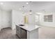 Kitchen island featuring stainless steel dishwasher and sink with pendant lighting and tile flooring at 20660 N Confetti Ct, Maricopa, AZ 85138